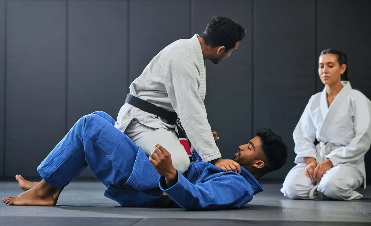 A Northgate MMA coach drilling a knee-on-belly pin with a student.